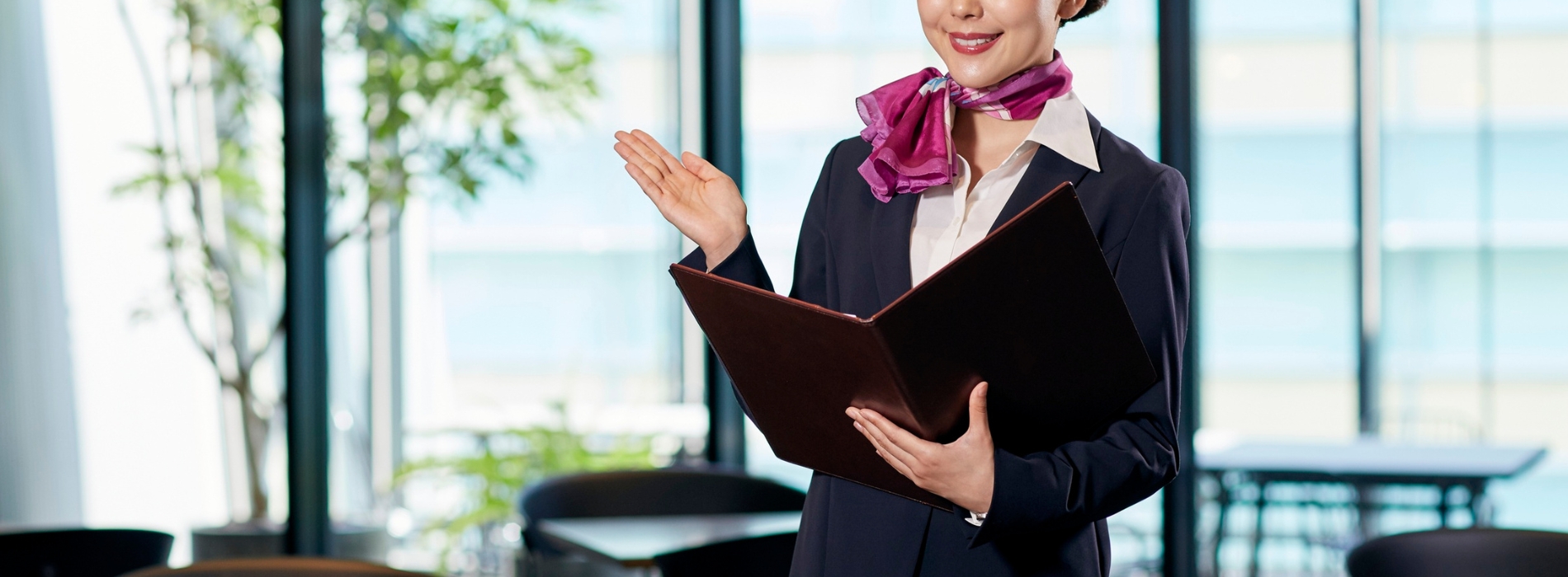 Corporate staff member wearing a pink and purple branded scarf with her uniform